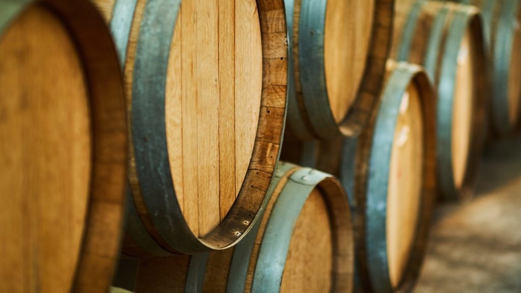 Wine barrels stacked in the old cellar of the winery.